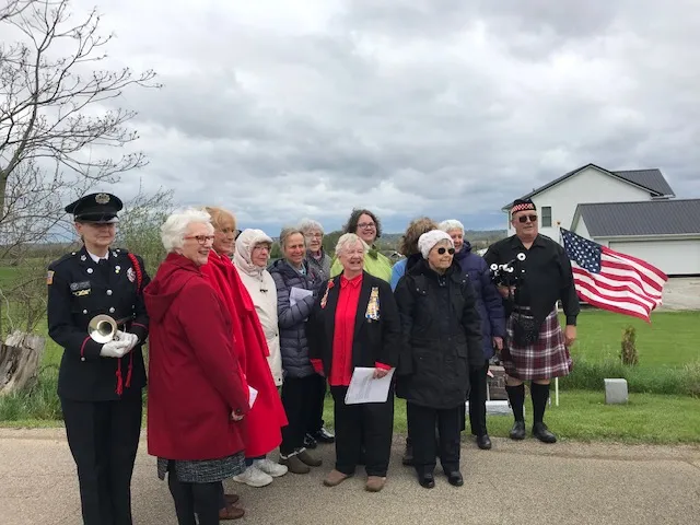 Chapter members with a bugler and bagpiper at the grave marking ceremony