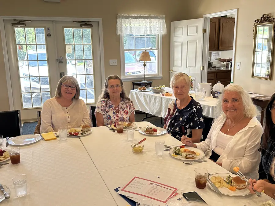 Members seated around a lunch table